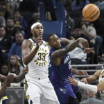 
              Charlotte Hornets guard Terry Rozier passes the ball away from Indiana Pacers center Myles Turner (33) during the second half of an NBA basketball game, Sunday, Jan. 8, 2023, in Indianapolis. (AP Photo/Marc Lebryk)
            