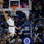
              Minnesota Timberwolves center Rudy Gobert (27) makes a basket over New Orleans Pelicans forward Naji Marshall (8) during the first half of an NBA basketball game in New Orleans, Wednesday, Jan. 25, 2023. (AP Photo/Matthew Hinton)
            