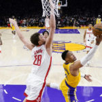 
              Los Angeles Lakers' Russell Westbrook (0) shoots under defense by Houston Rockets' Alperen Sengun (28) during the first half of an NBA basketball game Monday, Jan. 16, 2023, in Los Angeles. (AP Photo/Jae C. Hong)
            