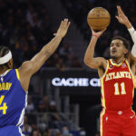 
              Atlanta Hawks guard Trae Young (11) shoots over Golden State Warriors guard Moses Moody (4) during the first half of an NBA basketball game in San Francisco, Monday, Jan. 2, 2023. (AP Photo/Jed Jacobsohn)
            