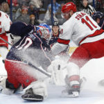 
              Columbus Blue Jackets goalie Joonas Korpisalo, front left, makes a stop in front of Carolina Hurricanes forward Jordan Staal during the first period of an NHL hockey game in Columbus, Ohio, Thursday, Jan. 12, 2023. (AP Photo/Paul Vernon)
            