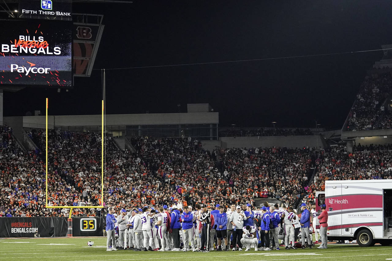 The Buffalo Bills players pray for teammate Damar Hamlin during the first half of an NFL football g...