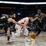 
              Toronto Raptors guard Fred VanVleet (23) attempts to advance past Charlotte Hornets forward Cody Martin (11) and guard Terry Rozier (3) during the first half of an NBA basketball game Tuesday, Jan. 10, 2023, in Toronto. (Christopher Katsarov/The Canadian Press via AP)
            