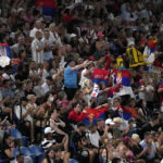 
              Supporters of Novak Djokovic of Serbia wave their national flag during his first round match against Roberto Carballes Baena of Spain at the Australian Open tennis championship in Melbourne, Australia, Tuesday, Jan. 17, 2023. (AP Photo/Aaron Favila)
            