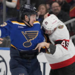 
              St. Louis Blues' Jake Neighbours and Ottawa Senators' Parker Kelly (45) fight during the second period of an NHL hockey game Monday, Jan. 16, 2023, in St. Louis. (AP Photo/Jeff Roberson)
            