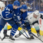 
              Seattle Kraken defenseman Vince Dunn (29) battles with Toronto Maple Leafs center Alexander Kerfoot (15) and center David Kampf (64) during the second period of an NHL hockey game Thursday, Jan. 5, 2023, in Toronto. (Frank Gunn/The Canadian Press via AP)
            