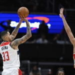 
              Washington Wizards forward Kyle Kuzma (33) shoots the ball for a 3-point basket against New Orleans Pelicans guard Dyson Daniels (11) during the first quarter of an NBA basketball game, Monday, Jan. 9, 2023, in Washington. (AP Photo/Terrance Williams)
            