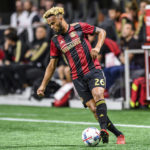 
              FILE - Atlanta United midfielder Anton Walkes (26) moves the ball during the first half of an MLS playoff soccer game, in Atlanta against Columbus Crew, Thursday, Oct. 26, 2017. Soccer player Anton Walkes, who started his career at Tottenham, died Thursday, Jan. 19, 2023, after an accident in Florida, his MLS club Charlotte FC said. He was 25. (AP Photo/Danny Karnik, File)
            