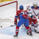 
              Montreal Canadiens goaltender Jake Allen is scored on by New York Rangers' Braden Schneider (not shown) as Rangers' Vincent Trocheck (16) and Canadiens' Jake Evans (71) look for a rebound during the second period of an NHL hockey game in Montreal on Thursday, Jan. 5, 2023. (Graham Hughes/The Canadian Press via AP)
            