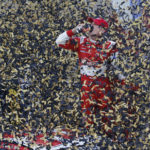 
              FILE - Driver Kevin Harvick celebrates in victory lane after winning the NASCAR Sprint Cup series auto race at Kansas Speedway in Kansas City, Kan., Sunday, Oct. 6, 2013. Kevin Harvick said Thursday, Jan. 12, 2023, he will retire from NASCAR competition at the end of the 2023 season. (AP Photo/Orlin Wagner, File)
            