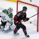 
              Dallas Stars goaltender Jake Oettinger (29) looks back to see a goal scored by Carolina Hurricanes' Sebastian Aho (20) during the first period of an NHL hockey game Wednesday, Jan. 25, 2023, in Dallas. (AP Photo/Tony Gutierrez)
            