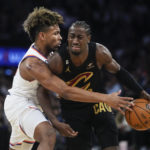 
              New York Knicks' Miles McBride, left, defends Cleveland Cavaliers' Caris LeVert, right, during the first half of an NBA basketball game Tuesday, Jan. 24, 2023, in New York. (AP Photo/Frank Franklin II)
            