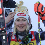 
              A crown is placed on United States' Mikaela Shiffrin's head after she won an alpine ski, women's World Cup giant slalom, in Kronplatz, Italy, Wednesday, Jan. 25, 2023. A day after securing record victory No. 83, Shiffrin added her 84th win on Wednesday in another giant slalom on the same course. (AP Photo/Alessandro Trovati)
            