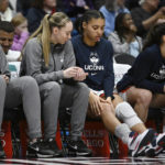 
              UConn's Paige Bueckers, second from left, looks down at teammate Azzi Fudd's knee in the second half of an NCAA college basketball game against Georgetown, Sunday, Jan. 15, 2023, in Hartford, Conn. Fudd left the game in the first half and did not return. (AP Photo/Jessica Hill)
            
