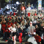
              University of Georgia students run through the streets after the NCAA College Football Playoff national championship game against TCU, Monday, Jan. 9, 2023, in Athens, Ga. (AP Photo/Alex Slitz)
            