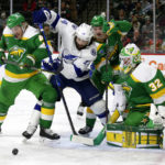 
              Tampa Bay Lightning left wing Pat Maroon (14) works for the puck against Minnesota Wild defenseman Jon Merrill (4) as Wild goaltender Filip Gustavsson (32) and defenseman Calen Addison (2) watch during the second period during an NHL hockey game Wednesday, Jan. 4, 2023, in St. Paul, Minn. (AP Photo/Andy Clayton-King)
            