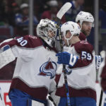 
              Colorado Avalanche goalie Alexandar Georgiev (40) and Ben Meyers (59) celebrate the team's win against the Vancouver Canucks in an NHL hockey game Friday, Jan. 20, 2023, in Vancouver, British Columbia. (Darryl Dyck/The Canadian Press via AP)
            