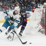 
              San Jose Sharks' Nick Bonino, left, carries the puck behind the net as Columbus Blue Jackets' Sean Kuraly defends during the first period of an NHL hockey game on Saturday, Jan. 21, 2023, in Columbus, Ohio. (AP Photo/Jay LaPrete)
            