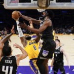 
              Sacramento Kings forward Chimezie Metu, right, blocks a shot by Los Angeles Lakers forward LeBron James (6) during the second half of an NBA basketball game in Los Angeles, Wednesday, Jan. 18, 2023. (AP Photo/Ashley Landis)
            