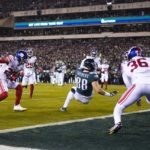 
              Philadelphia Eagles tight end Dallas Goedert (88) scores a touchdown on a pass from quarterback Jalen Hurts, not visible, as New York Giants players surround him during the first half of an NFL divisional round playoff football game, Saturday, Jan. 21, 2023, in Philadelphia. (AP Photo/Matt Rourke)
            