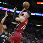 
              Miami Heat guard Tyler Herro (14) goes up for a shot against New Orleans Pelicans guard CJ McCollum (3) during the first half of an NBA basketball game, Sunday, Jan. 22, 2023, in Miami. (AP Photo/Wilfredo Lee)
            