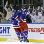 
              New York Rangers defenseman Adam Fox (23) is congratulated by Artemi Panarin (10) after scoring a goal in overtime to defeat the Dallas Stars in an NHL hockey game Thursday, Jan. 12, 2023, in New York. (AP Photo/Adam Hunger)
            