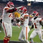 
              Kansas City Chiefs running back Isiah Pacheco, center, is congratulated by teammates Andrew Wylie, left, and Jerick McKinnon (1) after scoring during the second half of an NFL football game against the Las Vegas Raiders Saturday, Jan. 7, 2023, in Las Vegas. (AP Photo/John Locher)
            