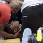 
              North Carolina State player Terquavion Smith, bottom, is tended by medical personnel after he crashed to the floor after being fouled during the second half of an NCAA college basketball game against North Carolina, Saturday, Jan. 21, 2023, in Chapel Hill, N.C. (AP Photo/Chris Seward)
            