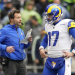 
              Los Angeles Rams head coach Sean McVay, left, talks to quarterback Baker Mayfield during the first half of an NFL football game Sunday, Jan. 8, 2023, in Seattle. (AP Photo/Abbie Parr)
            