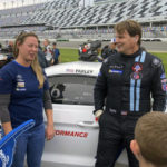 
              Ford CEO Jim Farley posing with fans on at Daytona International Speedway, Saturday, Jan. 21, 2023, in Daytona Beach, Fla., ahead of the IMSA Vo Racing SportsCar Challenge motor race. It was the professional racing debut for the 60-year-old chief executive of Ford Motor Co. He finished 12th. (AP Photo/Jenna Fryer)
            