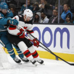 
              San Jose Sharks left wing Jonah Gadjovich (42) and New Jersey Devils defenseman Brendan Smith (2) compete for possession of the puck in the first period of an NHL hockey game on Monday, Jan. 16, 2023, in San Jose, Calif. (AP Photo/Josie Lepe)
            