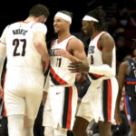 
              Portland Trail Blazers center Jusuf Nurkic, left, guard Josh Hart, center, and forward Jerami Grant, right, react after Grant scored during the second half of an NBA basketball game against the Detroit Pistons, in Portland, Ore., Monday, Jan. 2, 2023. (AP Photo/Steve Dykes)
            