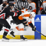 
              Buffalo Sabres center Peyton Krebs checks Philadelphia Flyers center Kevin Hayes (13) during the second period of an NHL hockey game, Monday, Jan. 9, 2023, in Buffalo, N.Y. (AP Photo/Jeffrey T. Barnes)
            