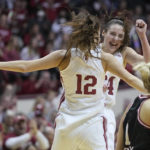 
              Indiana's Yarden Garzon (12) and Mackenzie Holmes celebrate as Nebraska's Jaz Shelley (1) walks past during overtime of an NCAA college basketball game, Sunday, Jan. 1, 2023, in Bloomington, Ind. (AP Photo/Darron Cummings)
            