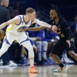 
              Golden State Warriors guard Donte DiVincenzo (0) is defended by Cleveland Cavaliers guard Darius Garland (10) during the first half of an NBA basketball game Friday, Jan. 20, 2023, in Cleveland. (AP Photo/Ron Schwane)
            