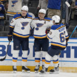 
              St. Louis Blues' Brayden Schenn, center, is congratulated by Niko Mikkola (77) and Jake Neighbours (63) after scoring during the second period of an NHL hockey game against the Nashville Predators Thursday, Jan. 19, 2023, in St. Louis. (AP Photo/Jeff Roberson)
            