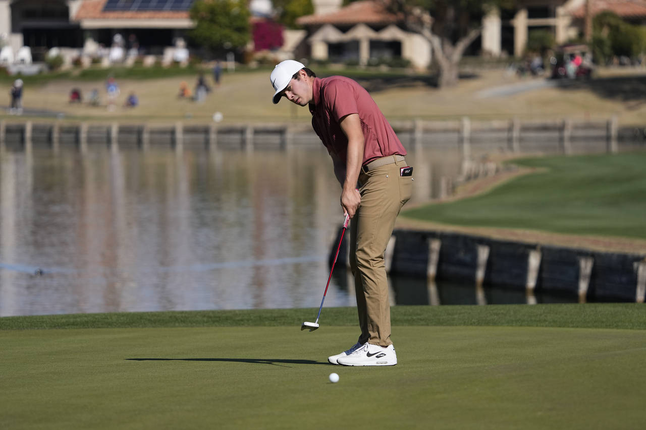 Davis Thompson putts on the seventh hole during the final round of the American Express golf tourna...