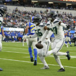 
              FILE - Seattle Seahawks cornerback Tariq Woolen (27) celebrates after intercepting a Los Angeles Rams pass during the first half of an NFL football game Dec. 4, 2022, in Inglewood, Calif. New York Jets cornerback Ahmad “Sauce” Gardner, Detroit Lions defensive end Aidan Hutchinson and Woolen are the finalists for AP Defensive Rookie of the Year. (AP Photo/Marcio Jose Sanchez, File)
            