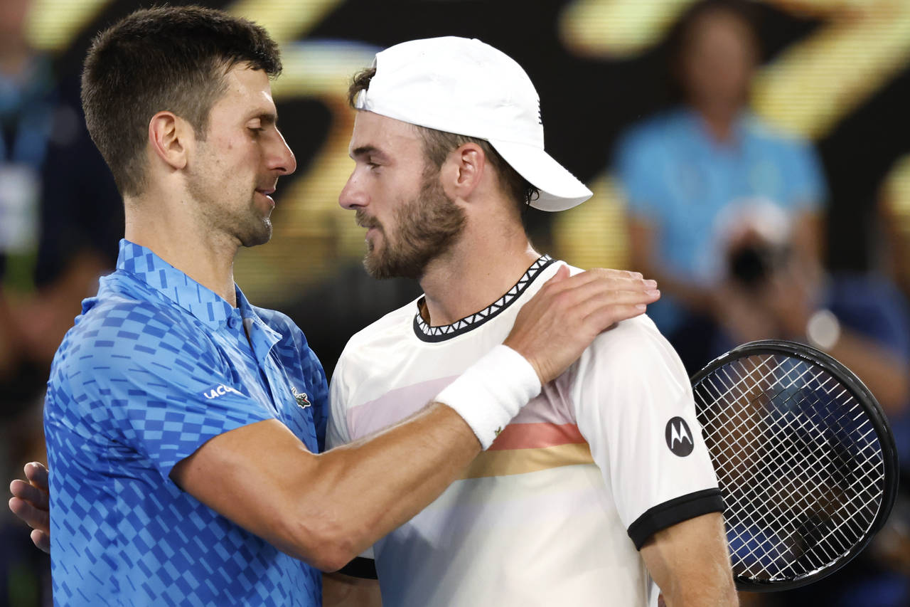 Novak Djokovic, left, of Serbia is congratulated by Tommy Paul of the U.S. after their semifinal at...