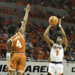 
              Oklahoma State guard Avery Anderson III (0) takes a shot while Texas guard Tyrese Hunter (4) defends during the first half NCAA college basketball game Saturday, Jan. 7, 2023, in Stillwater, Okla. Texas defeated Oklahoma State 56-46. (AP Photo/Brody Schmidt)
            