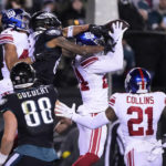
              New York Giants safety Dane Belton, top right, intercepts a pass from Philadelphia Eagles quarterback Jalen Hurts, not visible, intended for wide receiver DeVonta Smith, top center, during the second half of an NFL football game, Sunday, Jan. 8, 2023, in Philadelphia. (AP Photo/Matt Rourke)
            