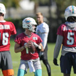 
              Miami Dolphins quarterback Skylar Thompson, center, runs a drill as Teddy Bridgewater (5) and practice squad quarterback Mike Glennon (16) look on during practice at the NFL football team's practice facility, Wednesday, Jan. 11, 2023, in Miami Gardens, Fla. The Dolphins will play the Buffalo Bills in a wild-card game on Sunday. (AP Photo/Wilfredo Lee)
            