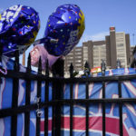 
              Balloons and a Buffalo Bills flag sit on a fence outside UC Medical Center, where Buffalo Bills safety Damar Hamlin remains hospitalized, Thursday, Jan. 5, 2023, in Cincinnati. Damar Hamlin has shown what physicians treating him are calling "remarkable improvement over the last 24 hours," the team announced on Thursday, three days after the player went into cardiac arrest and had to be resuscitated on the field. (AP Photo/Joshua A. Bickel)
            