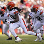 
              Cleveland Browns defensive end Jadeveon Clowney (90) rushes Washington Commanders quarterback Carson Wentz (11) during the first half of an NFL football game, Sunday, Jan. 1, 2023, in Landover, Md. (AP Photo/Patrick Semansky)
            