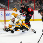 
              Pittsburgh Penguins defenseman Mark Friedman (52) dives in front of the net as Ottawa Senators left wing Tim Stützle (18) attempts a shot during the second period of an NHL hockey game Wednesday, Jan. 18, 2023, in Ottawa, Ontario. (Sean Kilpatrick/The Canadian Press via AP)
            