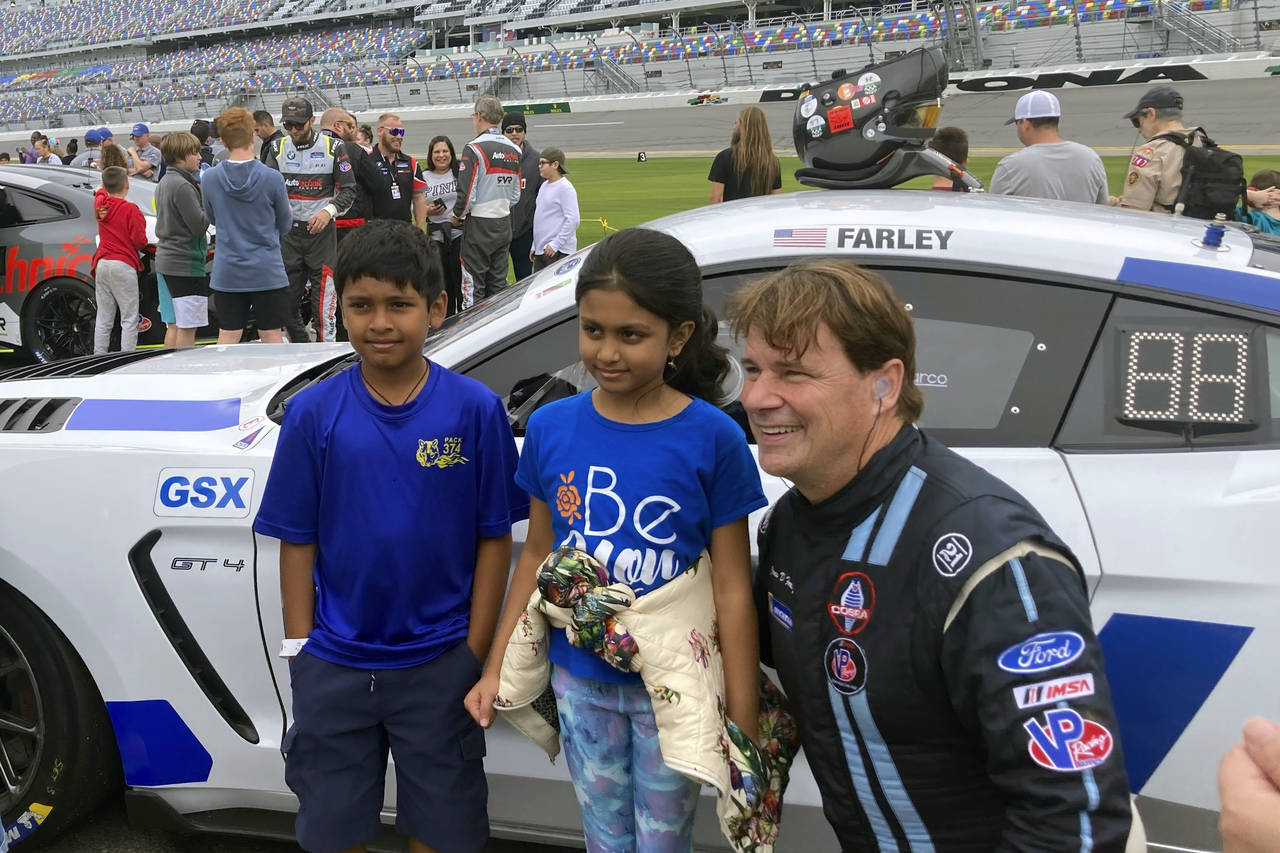 Ford CEO Jim Farley posing with fans on at Daytona International Speedway, Saturday, Jan. 21, 2023,...
