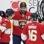 
              Florida Panthers defenseman Aaron Ekblad (5) celebrates after scoring with defenseman Brandon Montour (62) and center Aleksander Barkov (16) during the second period of an NHL hockey game against the Vancouver Canucks, Saturday, Jan. 14, 2023, in Sunrise, Fla. (AP Photo/Wilfredo Lee)
            