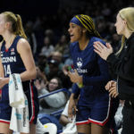 
              UConn's Dorka Juhasz (14) and Aaliyah Edwards, center, cheer from the bench during the second half of an NCAA college basketball game against Xavier, Thursday, Jan. 5, 2023, in Cincinnati. (AP Photo/Jeff Dean)
            