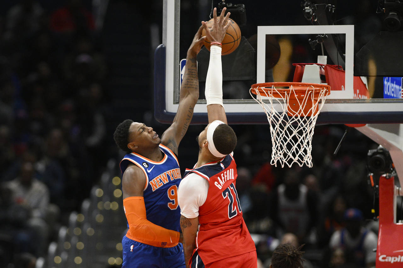 New York Knicks guard RJ Barrett (9) goes to the basket against Washington Wizards center Daniel Ga...