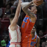 
              Oklahoma City Thunder guard Lindy Waters III, right, goes up for a shot against Miami Heat guard Max Strus during the first half of an NBA basketball game, Tuesday, Jan. 10, 2023, in Miami. (AP Photo/Wilfredo Lee)
            